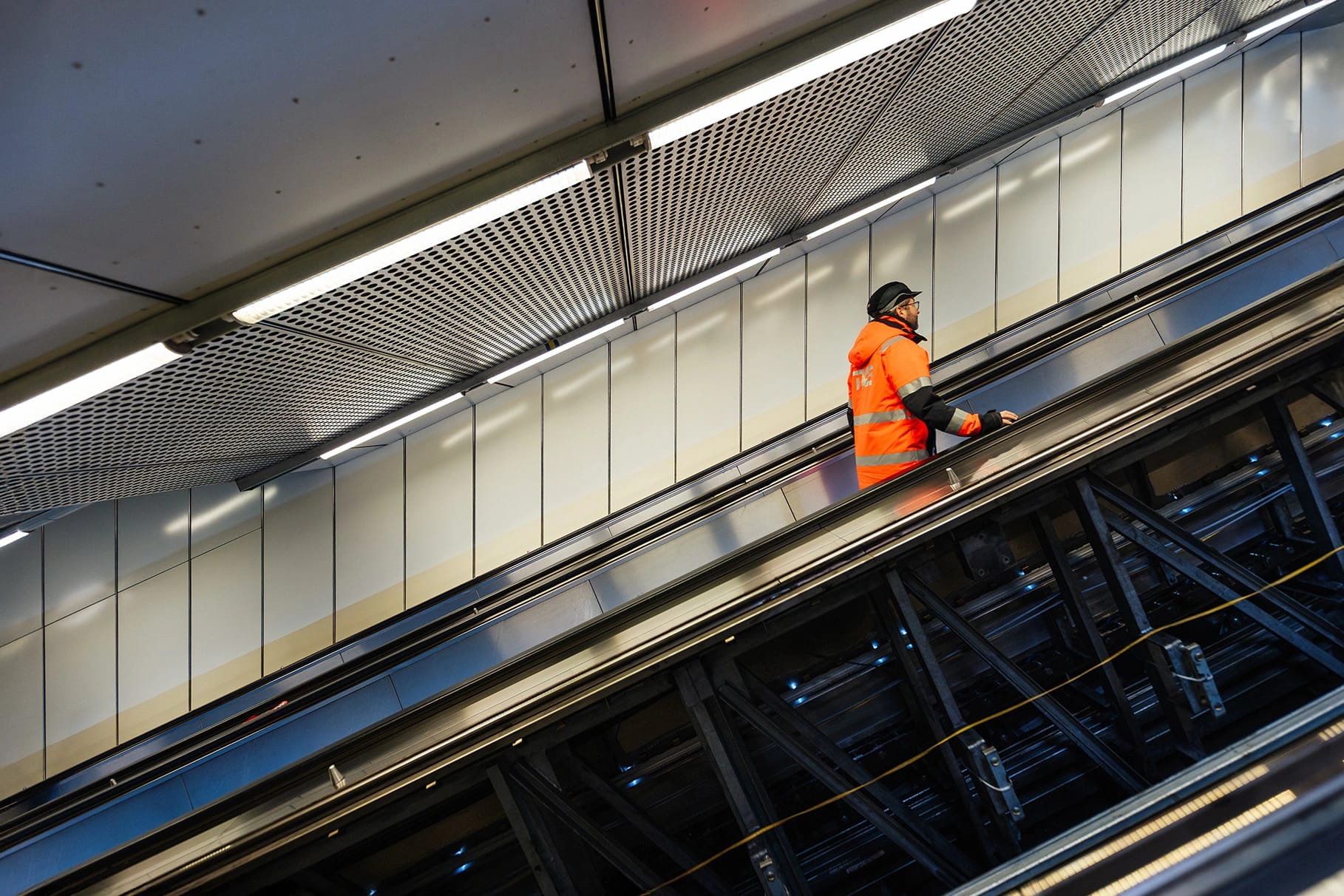 TK Elevator technician on an escalator